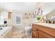 Charming bathroom with soaking tub, wood vanity, and textured walls at 732 Edgewater Dr, Orlando, FL 32804