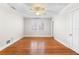 Bright bedroom with polished wood floors, ceiling fan, and large window with shutters at 732 Edgewater Dr, Orlando, FL 32804
