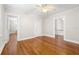 Spacious bedroom with gleaming hardwood floors and multiple doorways at 732 Edgewater Dr, Orlando, FL 32804