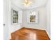 Bright, empty bedroom with hardwood floors, plantation shutters, and ceiling fan at 732 Edgewater Dr, Orlando, FL 32804
