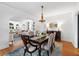 Dining room with chandelier, hardwood floors, and view of living area at 732 Edgewater Dr, Orlando, FL 32804