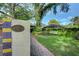 Landscaped front yard with a brick walkway and gate at 732 Edgewater Dr, Orlando, FL 32804