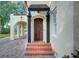 Front entrance with a wooden door and tiled steps at 732 Edgewater Dr, Orlando, FL 32804