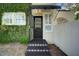 Side entrance with a black door and tiled steps at 732 Edgewater Dr, Orlando, FL 32804