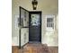 Black door with a stained-glass window and security gate at 732 Edgewater Dr, Orlando, FL 32804