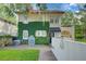Back exterior of house, featuring a courtyard and lush ivy at 732 Edgewater Dr, Orlando, FL 32804