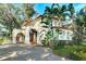 Spanish style home with a large driveway and lush landscaping at 732 Edgewater Dr, Orlando, FL 32804