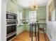 Cozy kitchen nook with a round table, bar stools, and contemporary light fixture at 732 Edgewater Dr, Orlando, FL 32804