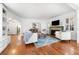 Bright living room with fireplace, hardwood floors, and view of the dining area at 732 Edgewater Dr, Orlando, FL 32804