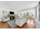 Living area with fireplace, white sofa, and wood floors at 732 Edgewater Dr, Orlando, FL 32804
