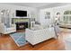Living room with fireplace, hardwood floors, and plush white furniture at 732 Edgewater Dr, Orlando, FL 32804
