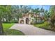 Spanish style home with tile roof, arched entry, and lush landscaping at 732 Edgewater Dr, Orlando, FL 32804