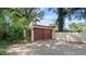 Two-car garage with brown doors and brick paver driveway at 732 Edgewater Dr, Orlando, FL 32804