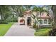 Two-story house with tile roof, arched entryway and brick driveway at 732 Edgewater Dr, Orlando, FL 32804