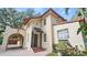 Spanish style home with tile roof, arched entryway, and brick driveway at 732 Edgewater Dr, Orlando, FL 32804