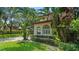 Spanish style home with arched windows and tropical landscaping at 732 Edgewater Dr, Orlando, FL 32804