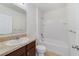 Clean bathroom with a shower/tub combo and dark brown vanity at 9021 Carlotta Way, Kissimmee, FL 34747