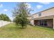 Landscaped backyard with a tree and privacy fence at 9021 Carlotta Way, Kissimmee, FL 34747
