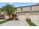 Two-car garage with beautiful landscaping and curb appeal at 9021 Carlotta Way, Kissimmee, FL 34747