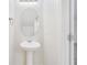 Small bathroom with pedestal sink and oval mirror at 9021 Carlotta Way, Kissimmee, FL 34747