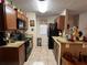 Galley style kitchen with granite countertops and dark cabinets at 575 Bloomington Ct # 27, Altamonte Springs, FL 32714