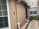 Building exterior with light brown siding, walkway, and landscaping at 575 Bloomington Ct # 27, Altamonte Springs, FL 32714