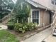 Exterior view of condo building showcasing landscaping and walkway at 575 Bloomington Ct # 27, Altamonte Springs, FL 32714