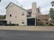 Two-story building with beige siding, multiple balconies, and landscaping at 575 Bloomington Ct # 27, Altamonte Springs, FL 32714