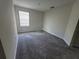 Bright bedroom with neutral carpeting and window at 1075 Trappers Trail Loop, Davenport, FL 33896