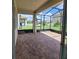 Relaxing screened patio with paver tile floor and view of backyard at 1075 Trappers Trail Loop, Davenport, FL 33896