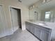 Spacious bathroom with double sinks and a separate toilet area at 1075 Trappers Trail Loop, Davenport, FL 33896