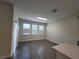 Bright dining room with wood-look floors and sliding glass doors at 1075 Trappers Trail Loop, Davenport, FL 33896