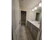 Modern bathroom with double vanity and large mirror at 1075 Trappers Trail Loop, Davenport, FL 33896