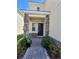 Front entry with stone accents, walkway, and lush landscaping at 1075 Trappers Trail Loop, Davenport, FL 33896