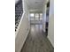 Bright foyer with wood-look tile floors and a staircase at 1075 Trappers Trail Loop, Davenport, FL 33896
