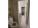 Bathroom with toilet and view into the vanity area at 1075 Trappers Trail Loop, Davenport, FL 33896