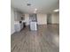 Open concept kitchen with gray cabinets, island, and stainless steel appliances at 1075 Trappers Trail Loop, Davenport, FL 33896