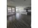 Open living area with wood-look floors and views into the kitchen at 1075 Trappers Trail Loop, Davenport, FL 33896