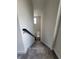 Modern carpeted staircase with simple black railing at 1075 Trappers Trail Loop, Davenport, FL 33896