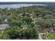 Aerial close-up view of a home located in a wooded neighborhood, near a lake at 2350 Pleasant Dr, Longwood, FL 32779