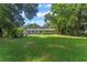 Spacious backyard with lush lawn, fire pit, and covered patio at 2350 Pleasant Dr, Longwood, FL 32779