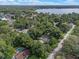 Aerial view of a home and property, surrounded by lush trees and near a lake at 2350 Pleasant Dr, Longwood, FL 32779