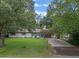 Single story home with a grassy yard and driveway at 2350 Pleasant Dr, Longwood, FL 32779