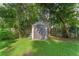 Large storage shed in backyard, surrounded by trees at 2350 Pleasant Dr, Longwood, FL 32779