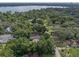 Aerial view of a home nestled in a wooded neighborhood near a lake at 2350 Pleasant Dr, Longwood, FL 32779