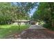 Charming ranch home with a covered carport and a neatly landscaped lawn at 2350 Pleasant Dr, Longwood, FL 32779