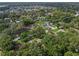 Aerial view of a house nestled in a lush, green neighborhood, near a lake at 2350 Pleasant Dr, Longwood, FL 32779