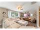 Relaxing living room with a large sectional sofa, TV, and ample natural light at 2350 Pleasant Dr, Longwood, FL 32779