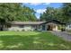 Charming ranch home with a covered carport and a neatly landscaped lawn at 2350 Pleasant Dr, Longwood, FL 32779