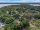 Aerial view of a home with a pool, surrounded by lush greenery near a lake at 2350 Pleasant Dr, Longwood, FL 32779
